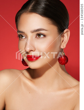 Portrait of beautiful young woman on red background 134588505