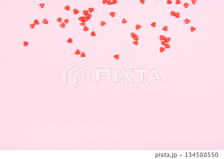 Tiny red hearts on pink background. Valentine's day concept. Top view. Tiny red hearts on pink background. Valentine's day concept. Top view. 134588550