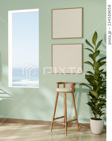 Wooden stool chair under blank photo frame near rectangular hole in green mint wall along a corridor Wooden stool chair under blank photo frame near rectangular hole in green mint wall along a corridor 134589058