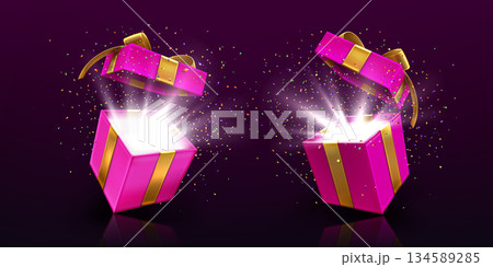 Open gift boxes with light and confetti on black 134589285