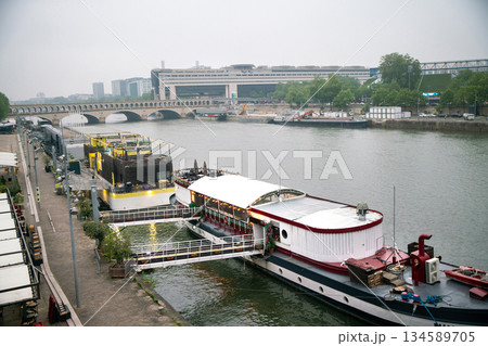 Morning on Seine riverbank embankmenrt- ship moored on right riverbank early at morning in springtime (May) Morning on Seine riverbank embankmenrt- ship moored on right riverbank early at morning in springtime (May) 134589705