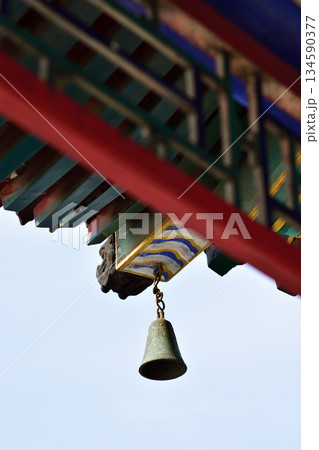 Traditional Temple Bell and Colorful Roof Detail 134590377