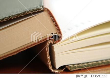 open book on a wooden table 134591558