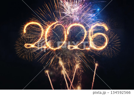 2026 New Year's Eve celebration. The year 2026 is written with a golden sparkler trail against a dazzling backdrop of colorful fireworks exploding in the dark night sky. Perfect for a festive holidays 2026 New Year's Eve celebration. The year 2026 is written with a golden sparkler trail against a dazzling backdrop of colorful fireworks exploding in the dark night sky. Perfect for a festive holidays 134592566