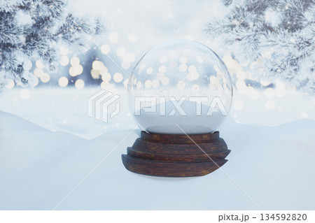 Blank Snow Globe Template. Empty glass snow globe on a wooden base in a festive, snowy winter landscape. Perfect for adding custom text, images, or figures for a personalized holiday greeting 134592820