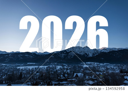 Majestic winter mountain landscape with the large number 2026 superimposed against a clear, cold blue sky. Represents New Year, future, travel, and adventure. New Year 2026, creative. 134592958