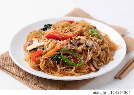 Japchae, Korean stir fried glass noodles with vegetables, pork, soy sauce and sesame oil Japchae, Korean stir fried glass noodles with vegetables, pork, soy sauce and sesame oil 134594864