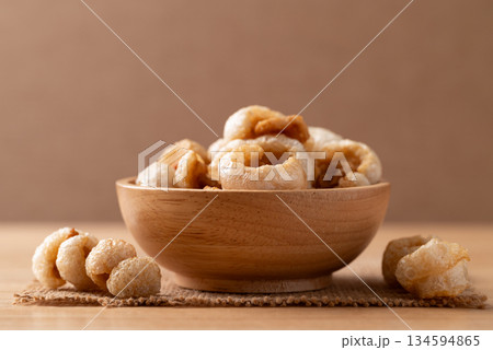 Pork rind in a wooden bowl, Northern Thai food Pork rind in a wooden bowl, Northern Thai food 134594865