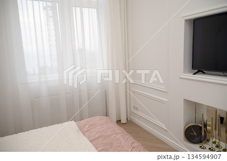 Bedroom interior, white decorative wall with TV, clock. Bedroom interior, white decorative wall with TV, clock. 134594907