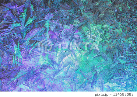 Natural ice texture on the frozen window in colorful light. Gradient color. Christmas background Natural ice texture on the frozen window in colorful light. Gradient color. Christmas background 134595095