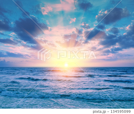 Beautiful sunset over the sea. Seascape with calm sea and cloudy sky Beautiful sunset over the sea. Seascape with calm sea and cloudy sky 134595099