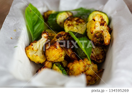 Delicious vegetarian baked vegetables with herbs and olive oil Delicious vegetarian baked vegetables with herbs and olive oil 134595269