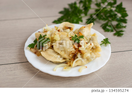 Ukrainian dumplings with potato filling and caramelized onions 134595274