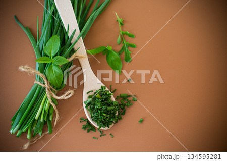 Slices of fresh and dried onions on brown surface 134595281