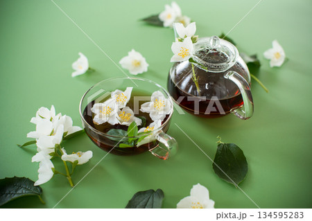 Green tea with jasmine in a glass teapot from above Green tea with jasmine in a glass teapot from above 134595283