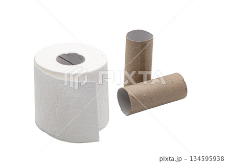 A soft roll of toilet paper with an embossed pattern next to two brown cardboard tubes. Concept of household, consumption, personal hygiene, and paper recycling. A soft roll of toilet paper with an embossed pattern next to two brown cardboard tubes. Concept of household, consumption, personal hygiene, and paper recycling. 134595938