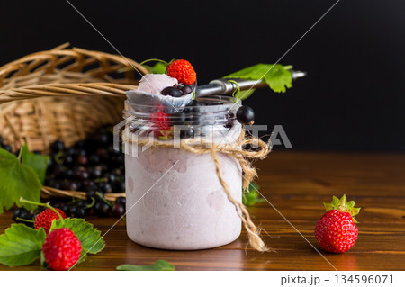 Sweet ice cream with berries on wooden background 134596071