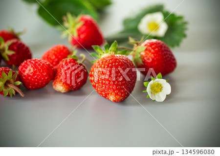 Juicy strawberries close-up on a gray background Juicy strawberries close-up on a gray background 134596080