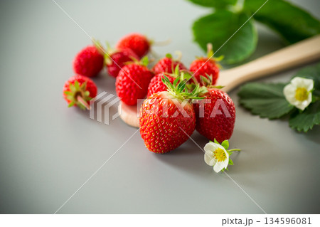 Bright ripe strawberries on a neutral gray surface Bright ripe strawberries on a neutral gray surface 134596081