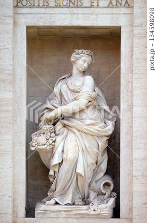 The statue of Abundance of the Trevi Fountain in Rome. Fontana di Trevi is one of the most famous landmark in Rome, Italy. 134598098