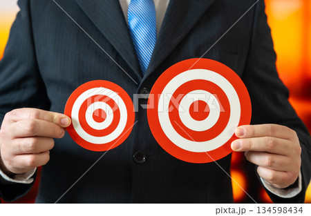 A businessman has a smaller and a larger goal. A minimum and a maximum goal. Choose one of the two. Ambition versus realism, risk tolerance. Strategic choice shaping growth and long term outcomes. 134598434