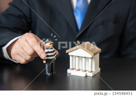 The bank and the bank robber. Keep your savings safe. Prevent money laundering. Financial crime prevention concept, banking security systems. Protection of deposits, compliance measures. The bank and the bank robber. Keep your savings safe. Prevent money laundering. Financial crime prevention concept, banking security systems. Protection of deposits, compliance measures. 134598451