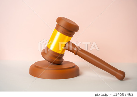 Judge's gavel on a pink and beige background. Justice and Lawmaking. Legal reforms. Judge's gavel on a pink and beige background. Justice and Lawmaking. Legal reforms. 134598462