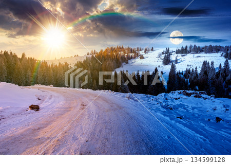 winter solstice landscape with snow covered country road winding through forest in mountains. day and night time change concept. alpine countryside with sun and moon. duality and transition template winter solstice landscape with snow covered country road winding through forest in mountains. day and night time change concept. alpine countryside with sun and moon. duality and transition template 134599128