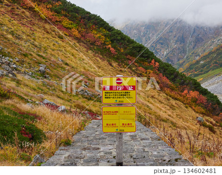 秋の観光名所立山黒部アルペンルートの室堂山頂の地獄谷の風景と通行止めの掲示板 134602481