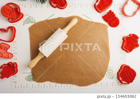 Rolled Cookie Dough with Christmas Holiday Cutters and Rolling Pin on Baking Mat Rolled Cookie Dough with Christmas Holiday Cutters and Rolling Pin on Baking Mat 134603062