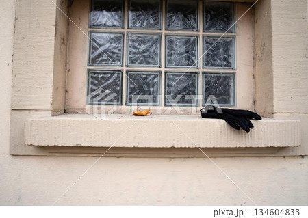 Black gloves on public bathroom window sill 134604833