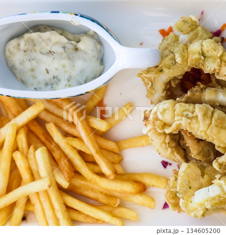 Shrimp in batter, French fries, and creamy garlic sauce Shrimp in batter, French fries, and creamy garlic sauce 134605200