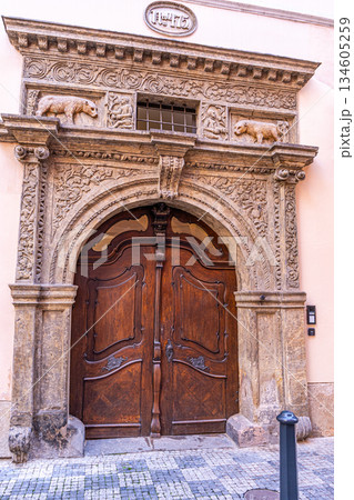 Prague, Czech Republic Old wooden door with bear in Praha street architecture. House entrance wall exterior building Prague, Czech Republic Old wooden door with bear in Praha street architecture. House entrance wall exterior building 134605259