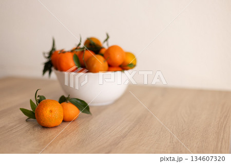 Full bowl of fresh tangerine on a wooden table. Full bowl of fresh tangerine on a wooden table. 134607320