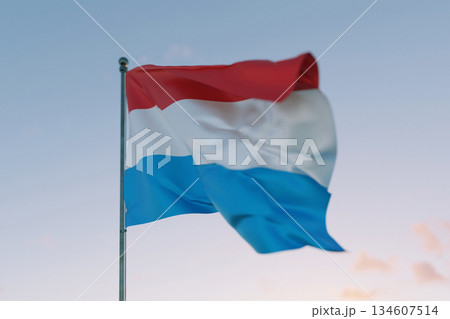 National flag of Luxembourg waving in the wind against a clear sky, symbolizing patriotism, independence, national pride, and unity. 134607514