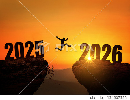 Man jumping on cliff 2026 over the precipice at amazing sunset. New Year's concept. Symbol of starting and welcome happy new year 2026. People enters the year 2026, creative idea 134607533