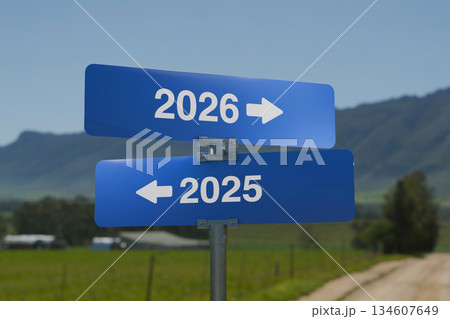 Two blue road signs with arrows pointing to 2025 and 2026, representing the concept of time, direction, new year, and the path toward the future. Two blue road signs with arrows pointing to 2025 and 2026, representing the concept of time, direction, new year, and the path toward the future. 134607649