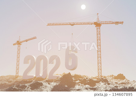 Construction cranes assembling large 3D numbers 2026 on a dirt landscape  134607895