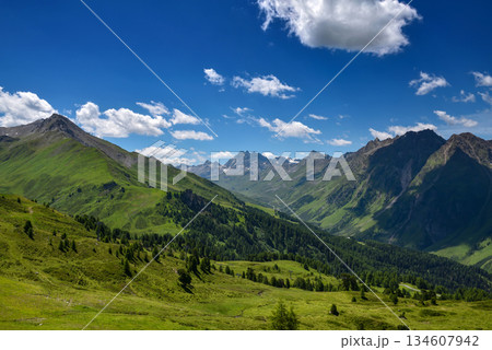 Rocky peaks in the Tirol Alps. Scenic mountain landscape with blue sky with clouds. Austria. Europe Rocky peaks in the Tirol Alps. Scenic mountain landscape with blue sky with clouds. Austria. Europe 134607942