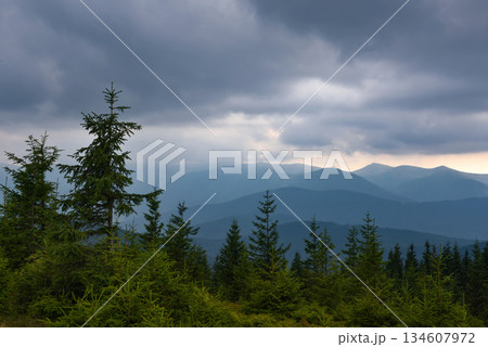 Wonderful summer panorama with mountains. A thunderstorm is coming. Rain Clouds Above Mountains. 134607972