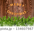 Merry Christmas cookies with stars and branches of spruce on dark wooden background.  134607987