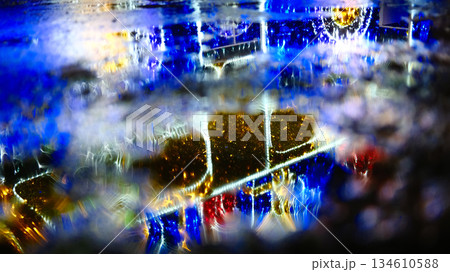 Wet pavement with neon city lights reflections Wet pavement with neon city lights reflections 134610588