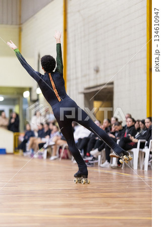 Artistic roller skater balancing during a performance Artistic roller skater balancing during a performance 134610947