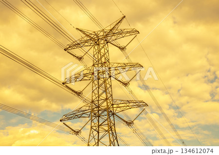 A large Transmission Tower set against an orange sky A large Transmission Tower set against an orange sky 134612074