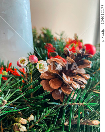 Pinecone and evergreen branches in holiday decor. Natural textures, seasonal symbolism, winter tradition, calm atmosphere and organic christmas styling details. 134612177