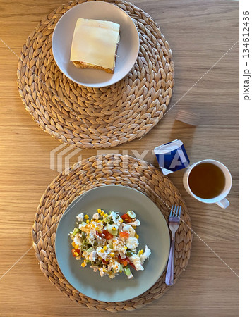 Simple breakfast table with eggs salad bread and tea. Balanced morning meal, home dining routine and calm lifestyle composition focused on nutrition and simplicity. Simple breakfast table with eggs salad bread and tea. Balanced morning meal, home dining routine and calm lifestyle composition focused on nutrition and simplicity. 134612436
