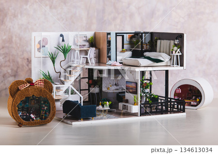 A miniature tiny replica of a residential house made by hand on a table A miniature tiny replica of a residential house made by hand on a table 134613034