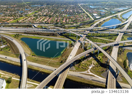 View from above of USA transportation infrastructure. American freeway intersection with fast driving cars and trucks in Miami, Florida 134613136