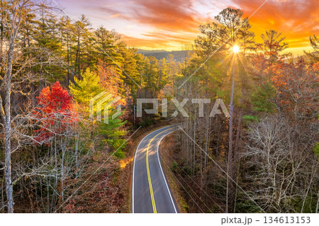 Vibrant autumn landscape in North Carolina mountains. Fall colors stretch across hillsides along quiet mountain road Vibrant autumn landscape in North Carolina mountains. Fall colors stretch across hillsides along quiet mountain road 134613153