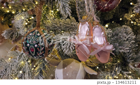 Festive christmas tree with ornaments and ballet slippers for holiday decoration. Horizontal banner. Copy space. For a dance studio or ballet school. Free space for text Festive christmas tree with ornaments and ballet slippers for holiday decoration. Horizontal banner. Copy space. For a dance studio or ballet school. Free space for text 134613211